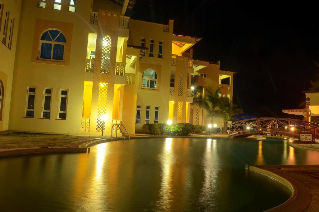 Guests relaxing by the pool at a Mombasa beach hotel